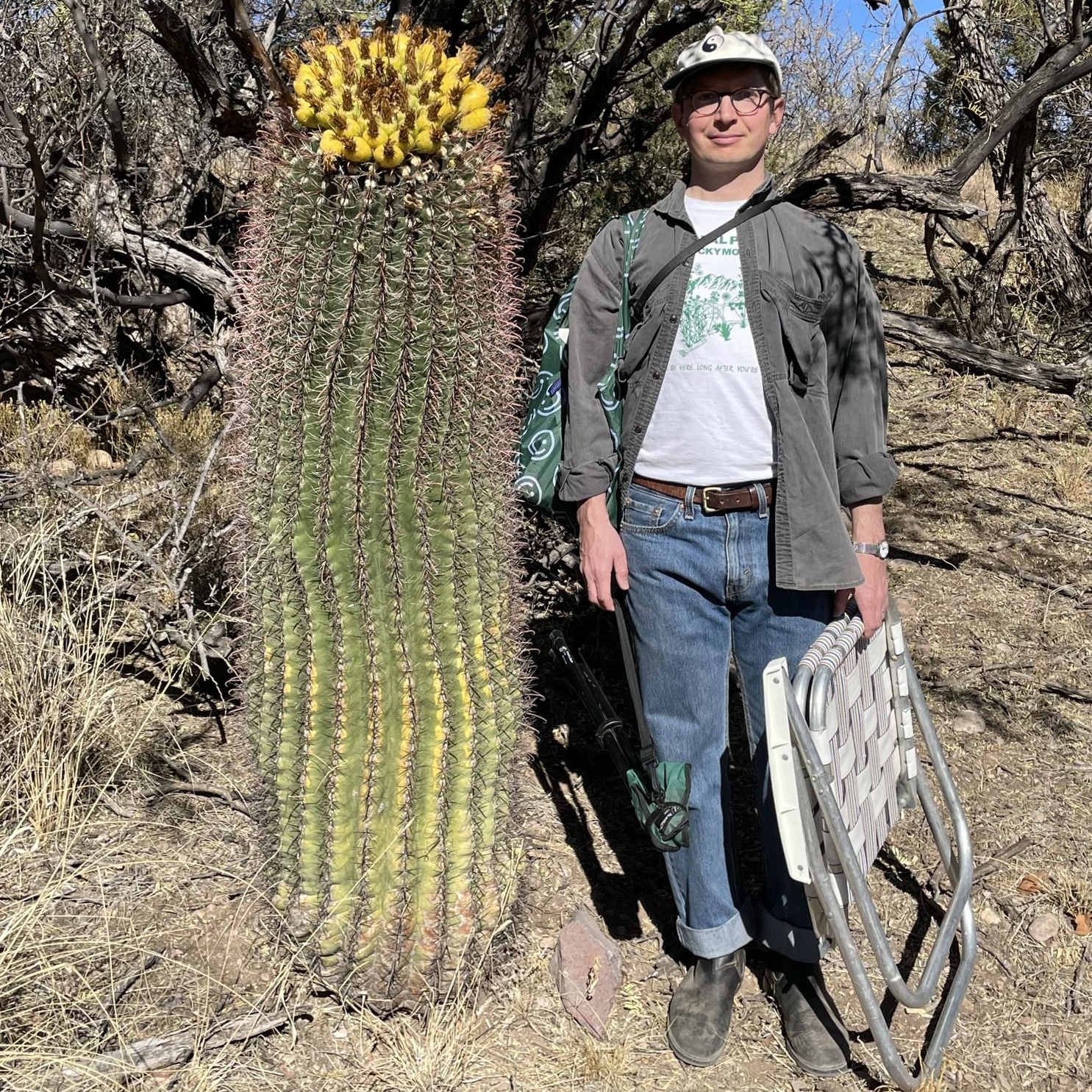 Paul CaraDonna standing next to a large barrel cactus